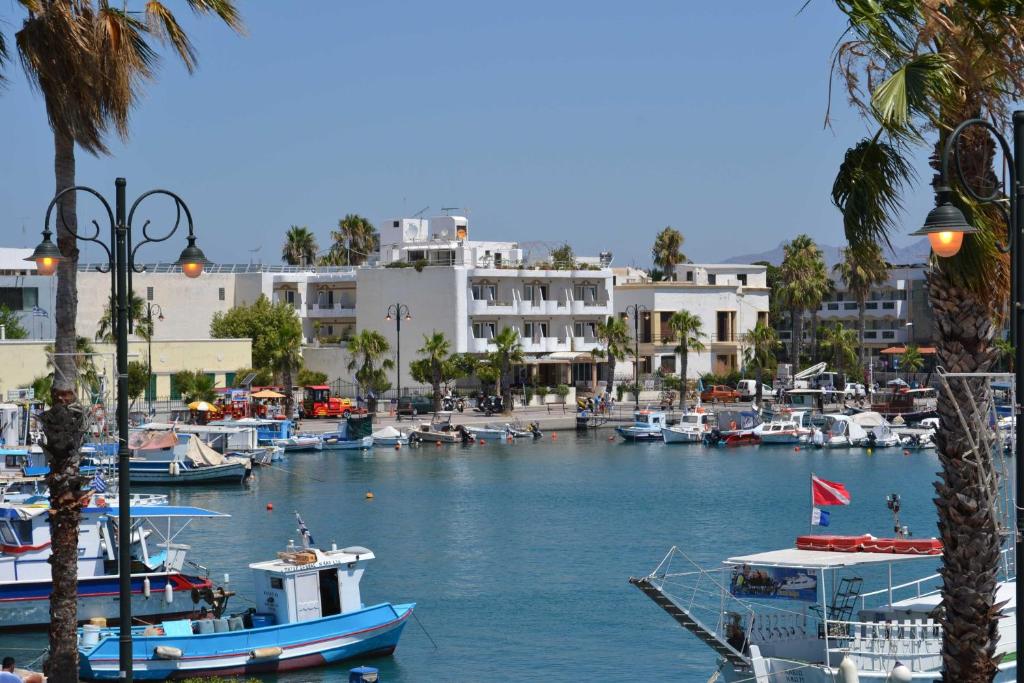 a group of boats docked in a harbor with buildings at Astron Hotel in Kos Town