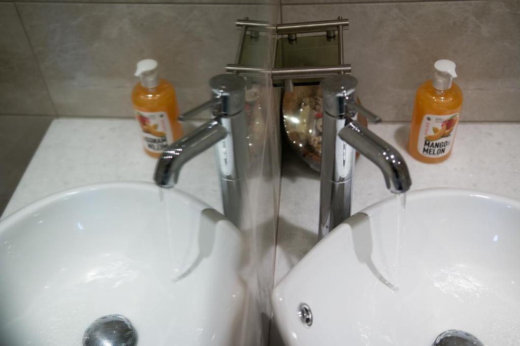 two sinks in a bathroom with two faucets at Relax Studios in Naxos Chora