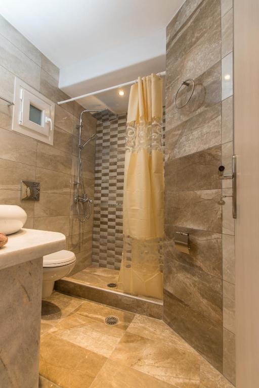 a bathroom with a shower and a toilet at Relax Studios in Naxos Chora