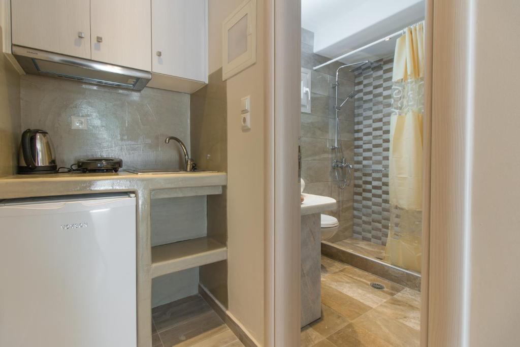a small bathroom with a sink and a shower at Relax Studios in Naxos Chora