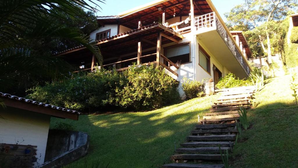 a house with stairs leading up to it at Chalé Serra Cantareira in Mairiporã