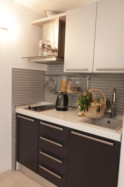 a kitchen with white cabinets and a counter top at Formula Fortunae BOL in Bol