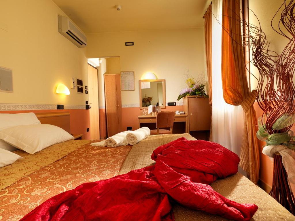 Postel nebo postele na pokoji v ubytování Hotel & Residence Roma