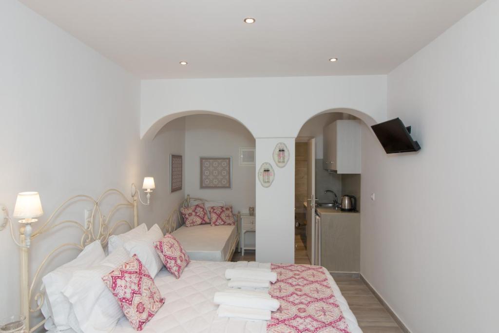 a bedroom with a bed and a living room at Relax Studios in Naxos Chora