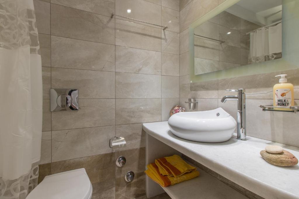 a bathroom with a sink and a toilet and a shower at Relax Studios in Naxos Chora