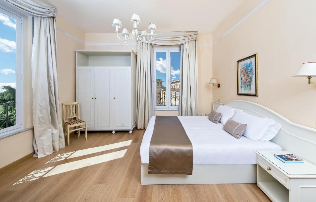 Postel nebo postele na pokoji v ubytování Hotel Ercolini & Savi