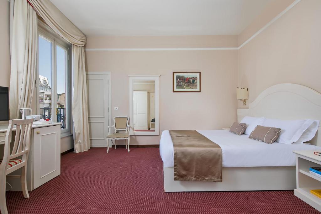 Postel nebo postele na pokoji v ubytování Hotel Ercolini & Savi