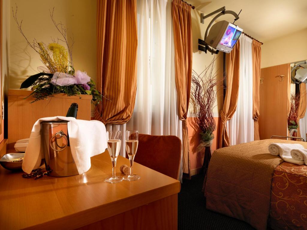 Postel nebo postele na pokoji v ubytování Hotel & Residence Roma