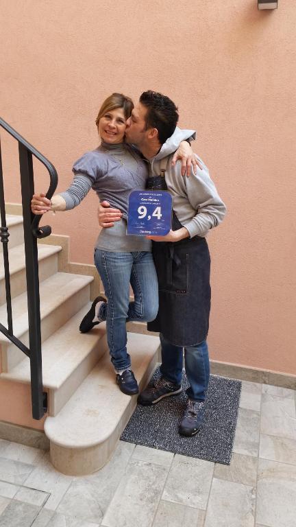 a man and a woman standing next to stairs at Casa Mafalda in Chioggia