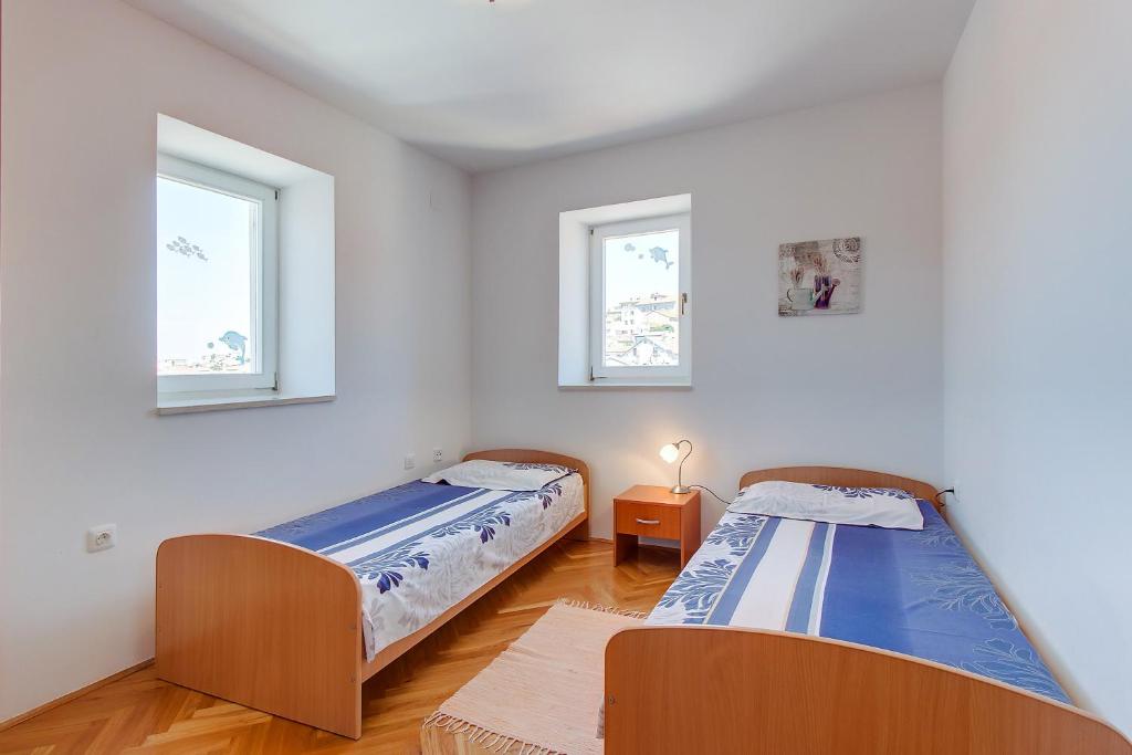 Posteľ alebo postele v izbe v ubytovaní Apartments Bellus Mare
