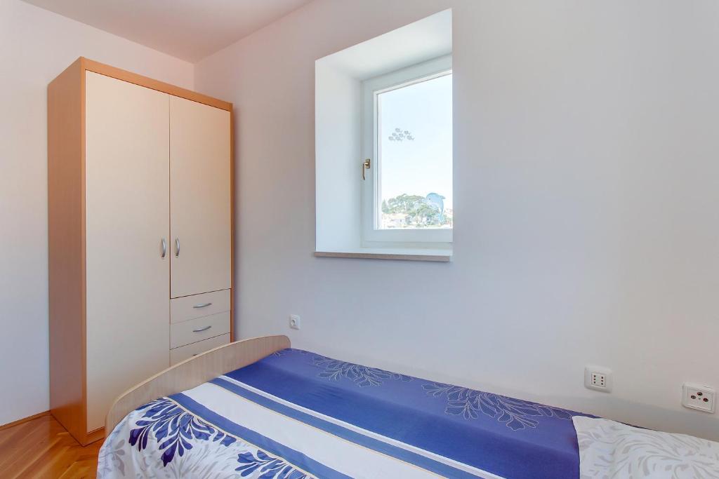 Posteľ alebo postele v izbe v ubytovaní Apartments Bellus Mare