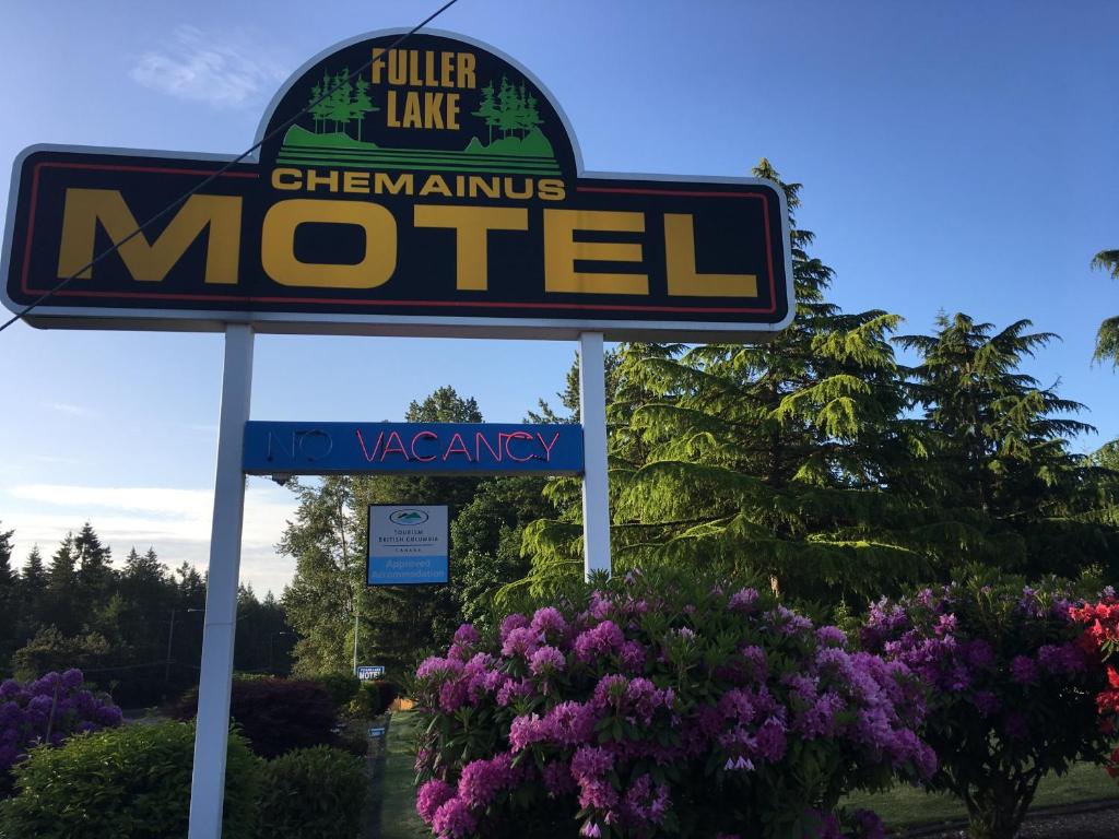 a sign for a motel with purple flowers at Fuller Lake Chemainus Motel in Chemainus