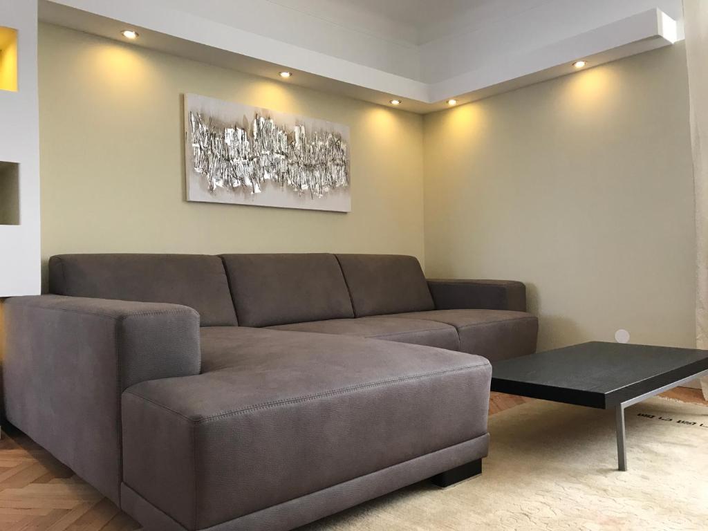 a living room with a brown couch and a table at Am Löwenpark in Melk