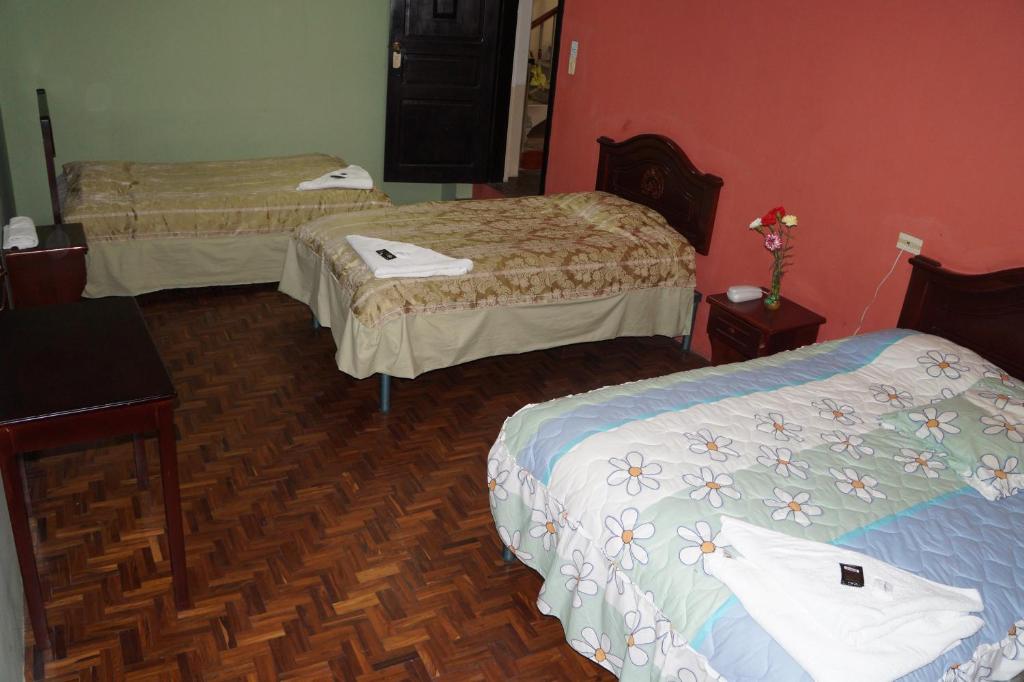 Postel nebo postele na pokoji v ubytování Hostal Pucará