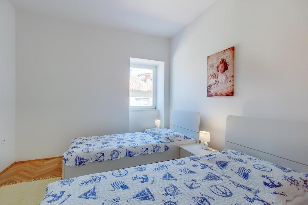 Posteľ alebo postele v izbe v ubytovaní Apartments Bellus Mare