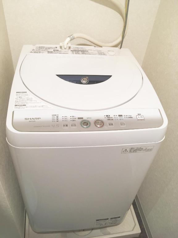 a toilet with a white seat and lid in a bathroom at City Hotel Universal Studios Japan in Osaka