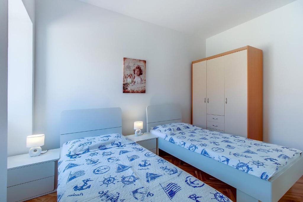 Posteľ alebo postele v izbe v ubytovaní Apartments Bellus Mare