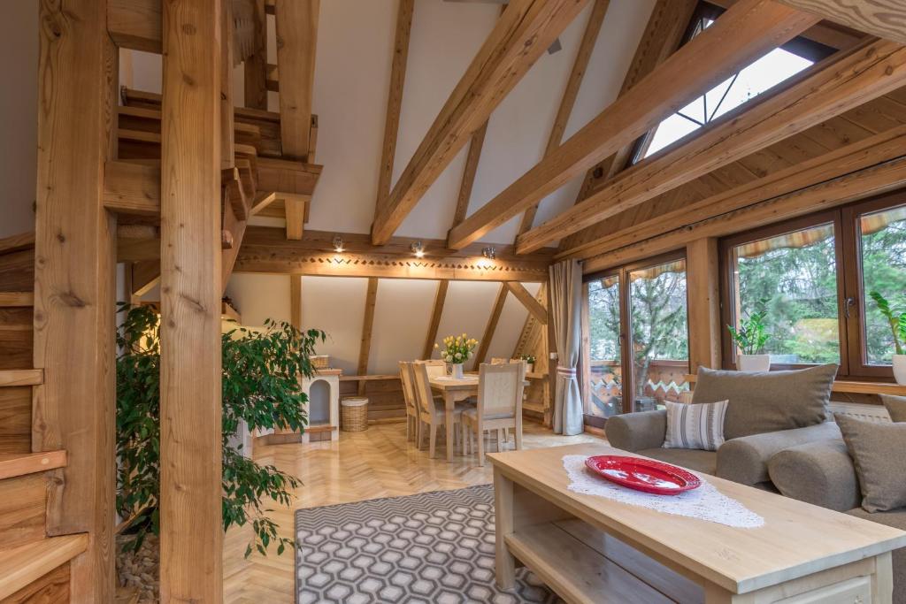 duży salon z drewnianym sufitem i stołem w obiekcie Willa TATIANA premium w Zakopanem