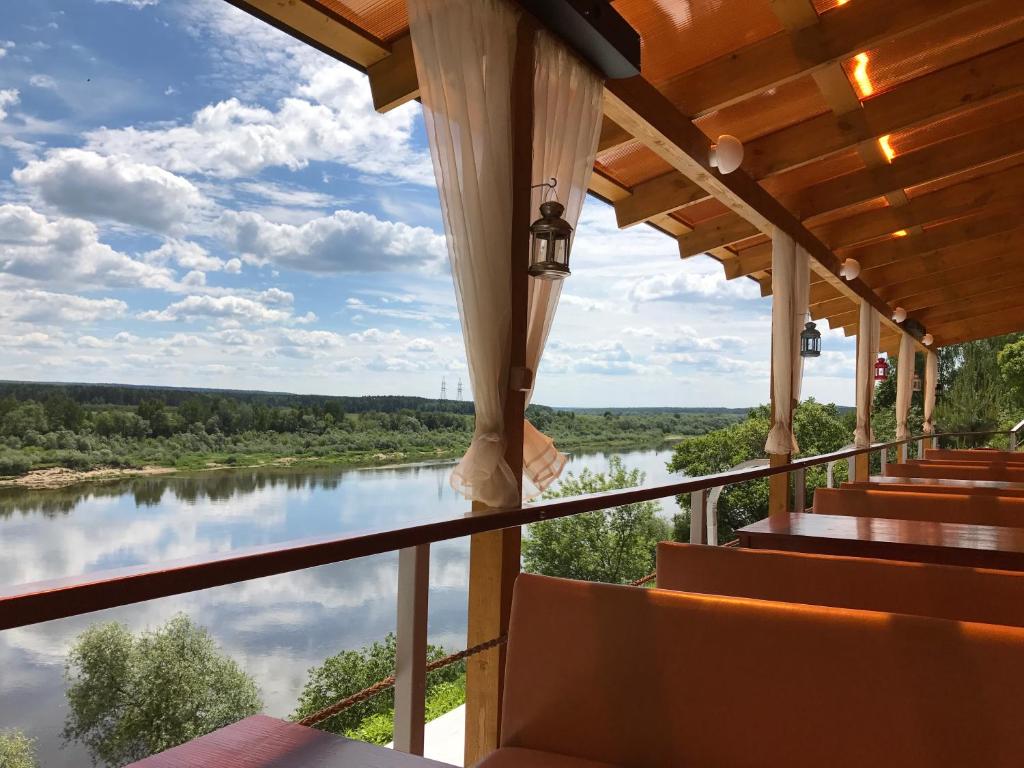 a view from the balcony of a house overlooking a river at Holiday Park Solnechnaya na Oke in Volkovskoye