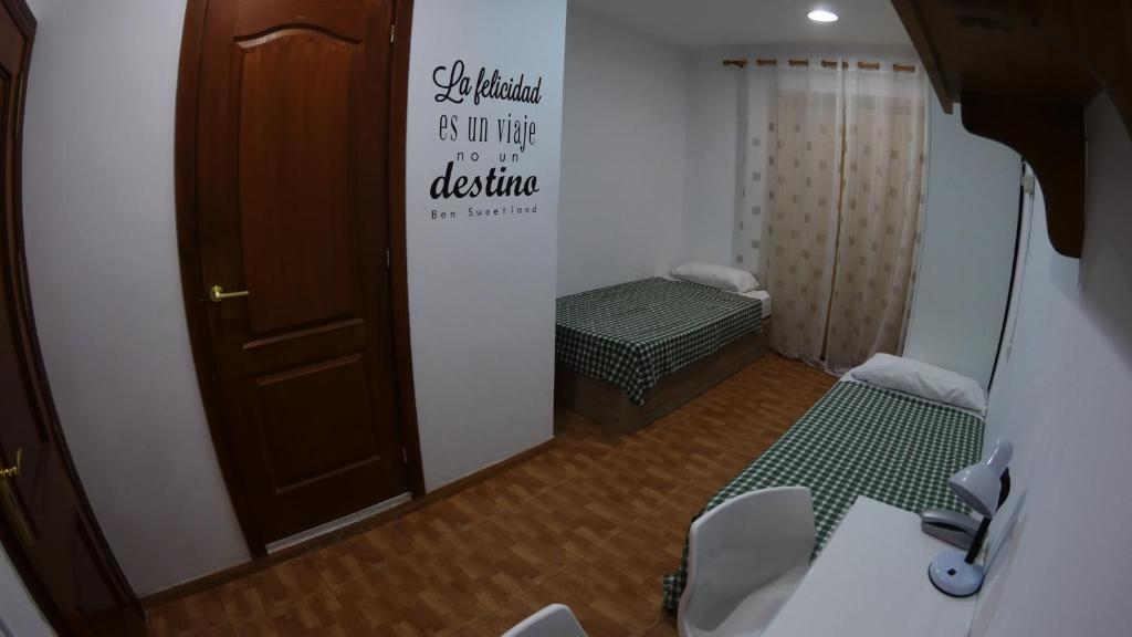 A bed or beds in a room at Rosales Residences