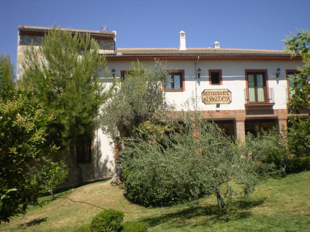 a building with trees in front of it at Balcón de los Montes in Colmenar