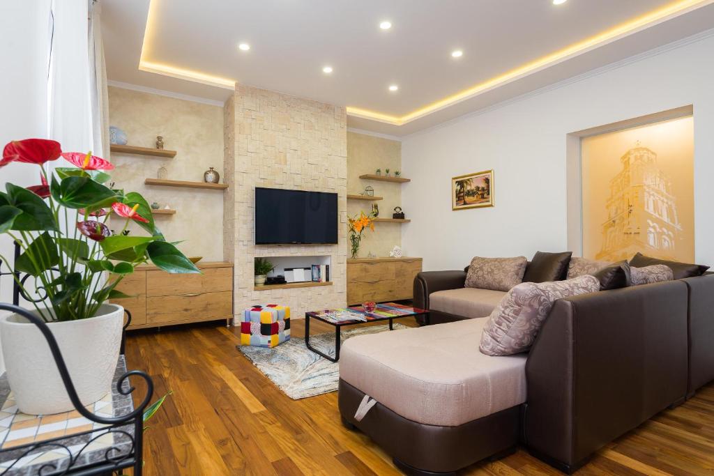 a living room with a couch and a tv at Luxury Apartment Luce in Split