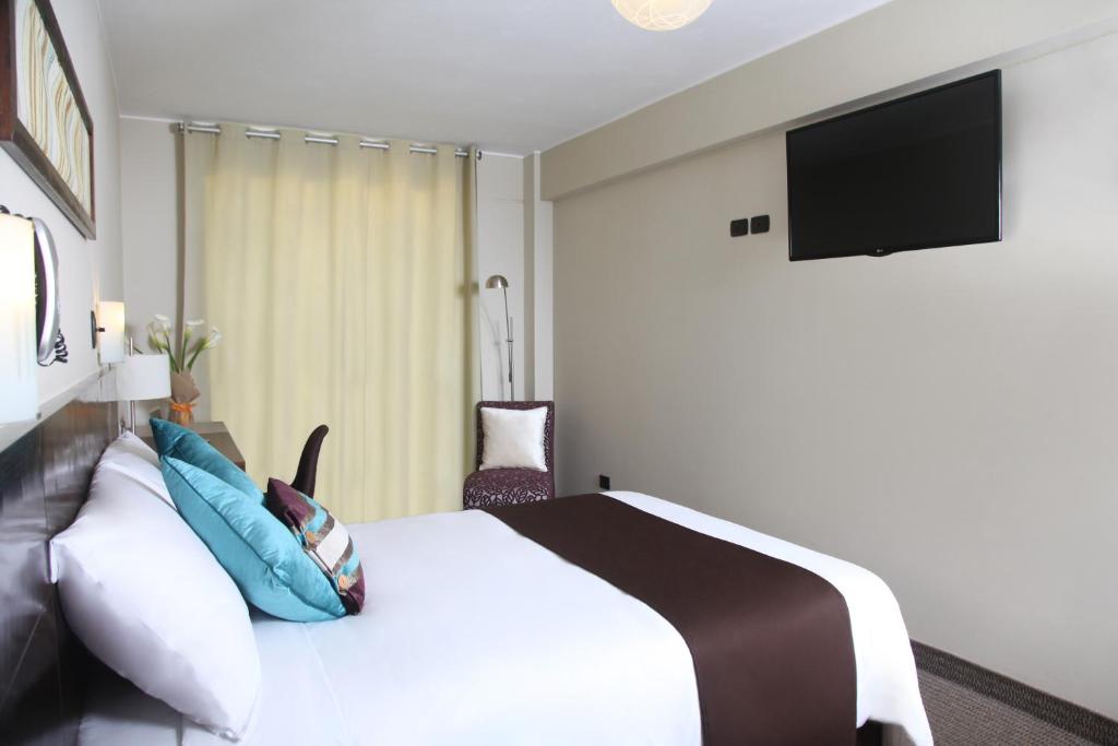 TV a/nebo společenská místnost v ubytování Hotel Rivera Inn