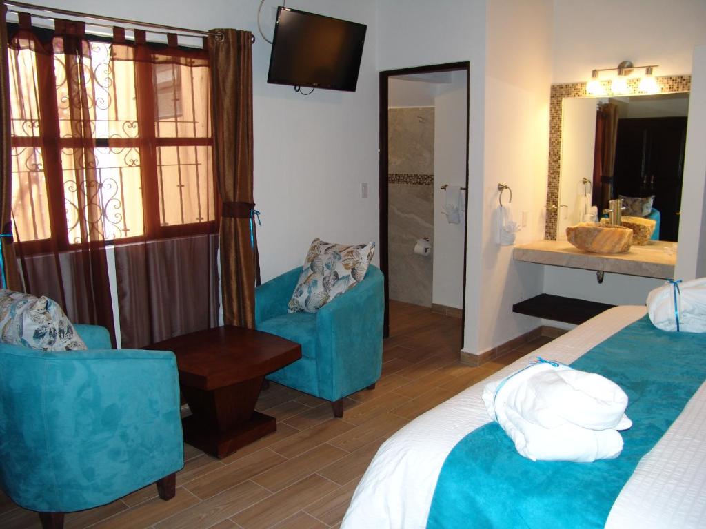 Postel nebo postele na pokoji v ubytování Hotel Casa Don Quijote