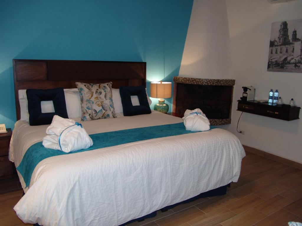 Postel nebo postele na pokoji v ubytování Hotel Casa Don Quijote