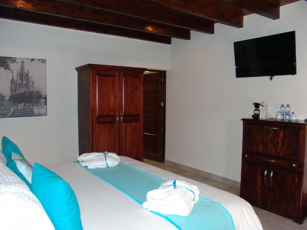 Postel nebo postele na pokoji v ubytování Hotel Casa Don Quijote