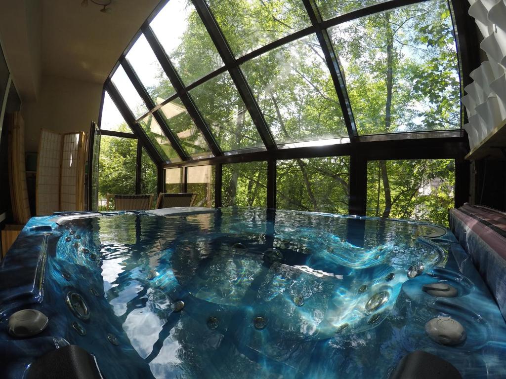 a round pool in a room with a large window at Willa Sunshine Zakopane Chalet in Zakopane