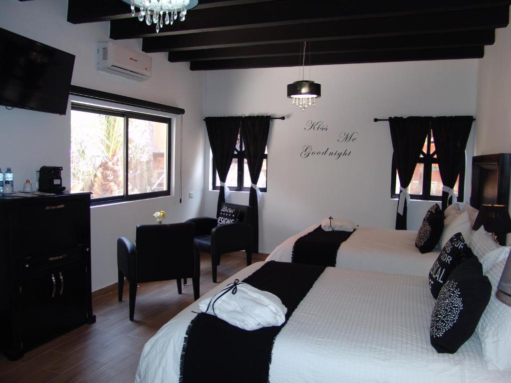 Postel nebo postele na pokoji v ubytování Hotel Casa Don Quijote