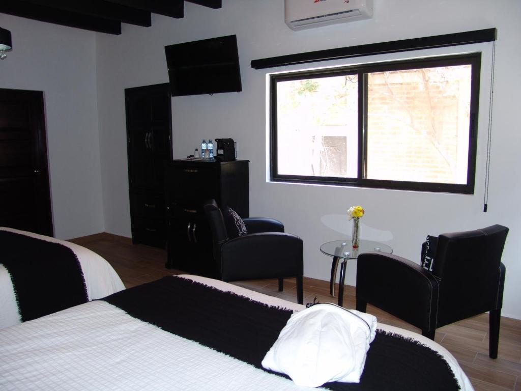 Postel nebo postele na pokoji v ubytování Hotel Casa Don Quijote