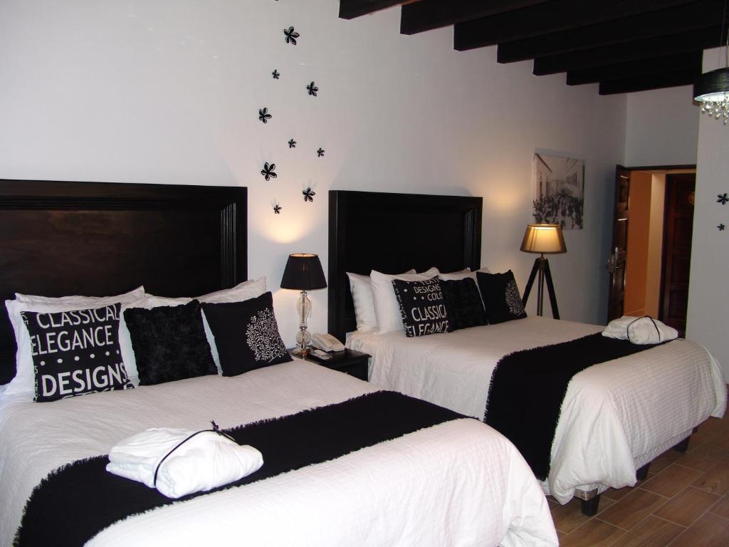 Postel nebo postele na pokoji v ubytování Hotel Casa Don Quijote