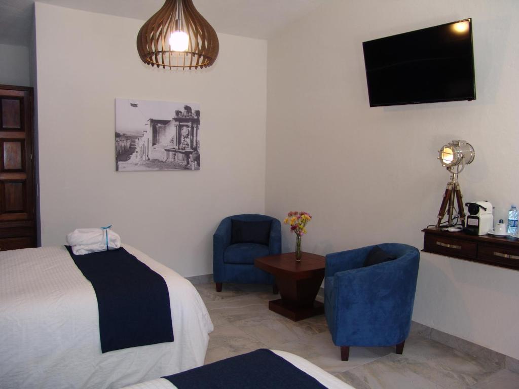 Postel nebo postele na pokoji v ubytování Hotel Casa Don Quijote
