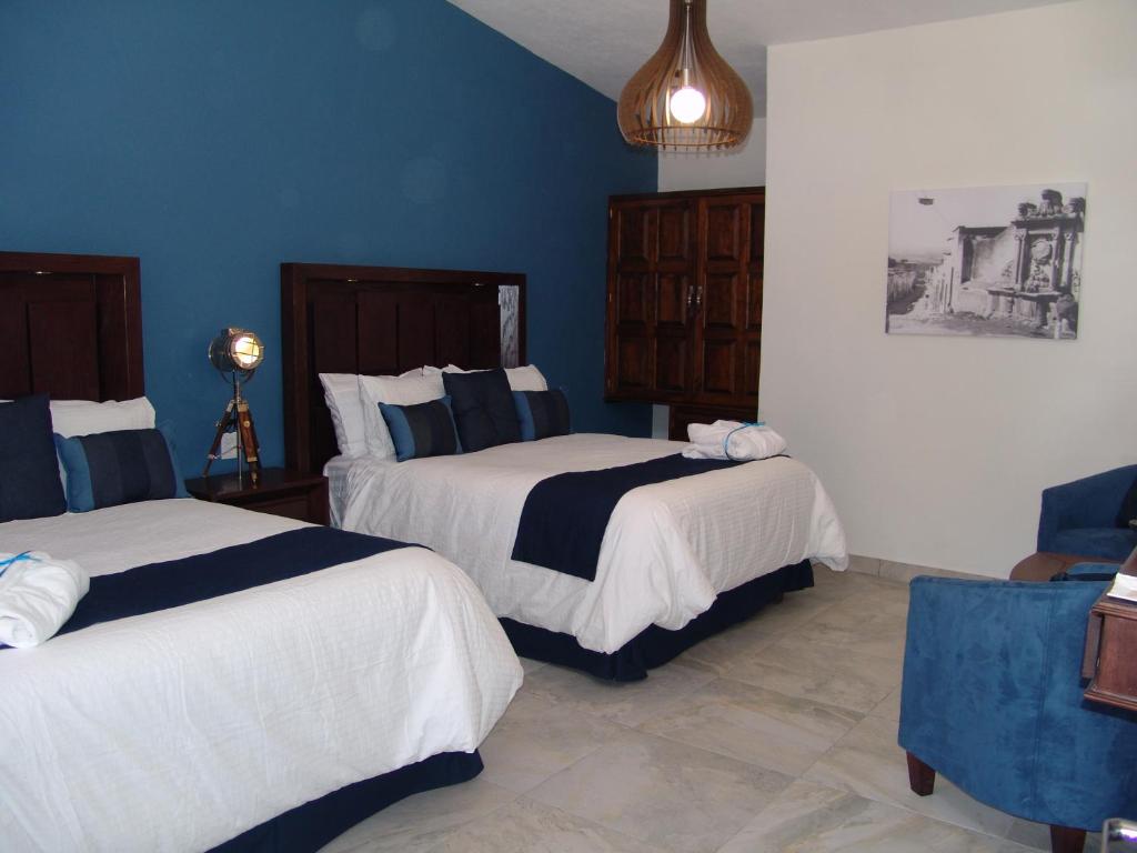 Postel nebo postele na pokoji v ubytování Hotel Casa Don Quijote