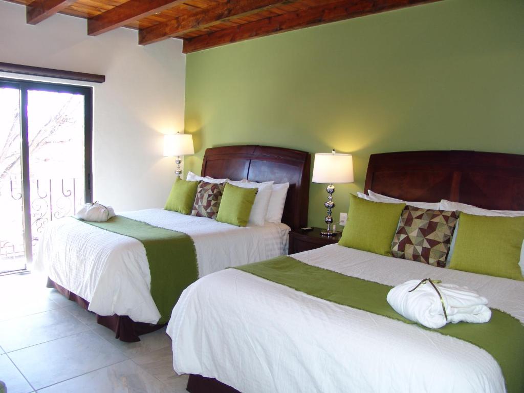 Postel nebo postele na pokoji v ubytování Hotel Casa Don Quijote