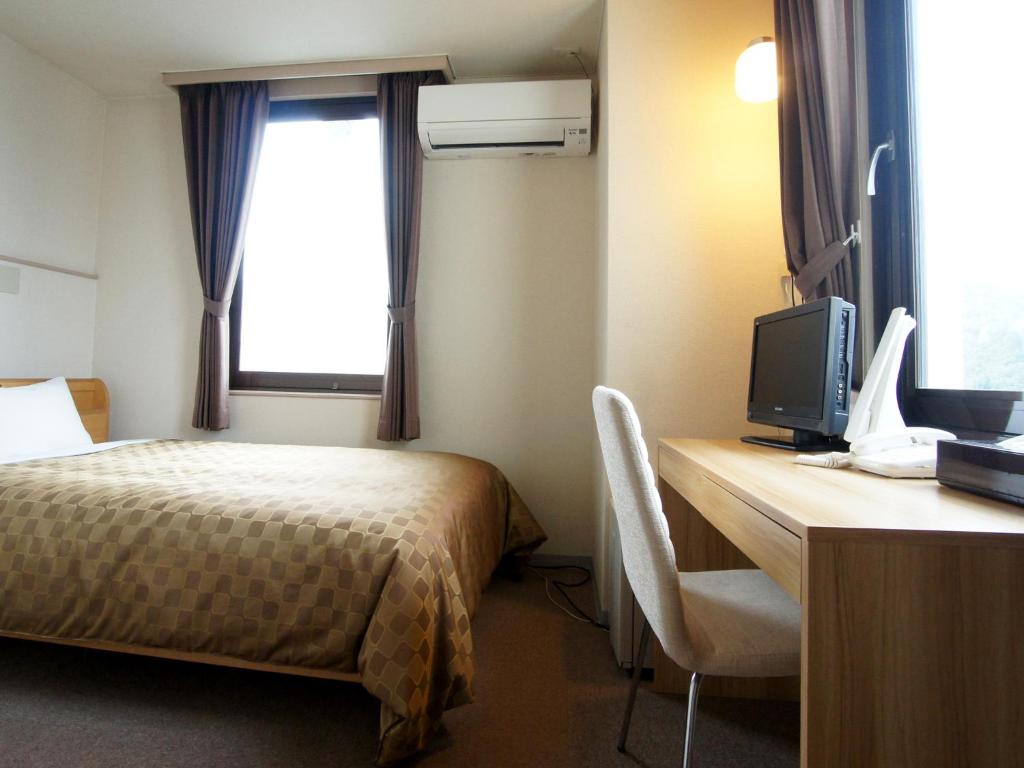 Postel nebo postele na pokoji v ubytování Hotel Trend Iwakuni