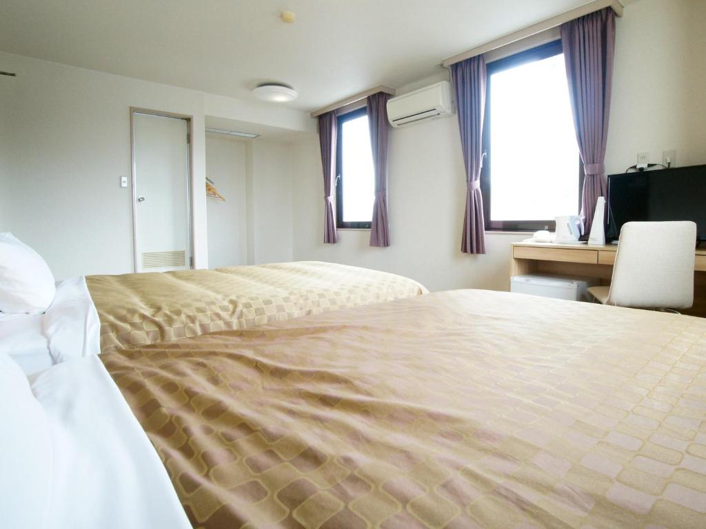 Postel nebo postele na pokoji v ubytování Hotel Trend Iwakuni