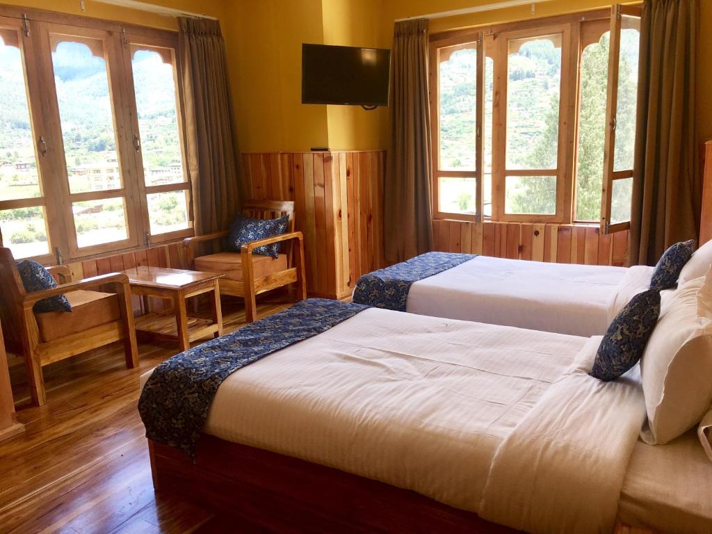 Postel nebo postele na pokoji v ubytování Hotel Khamsum