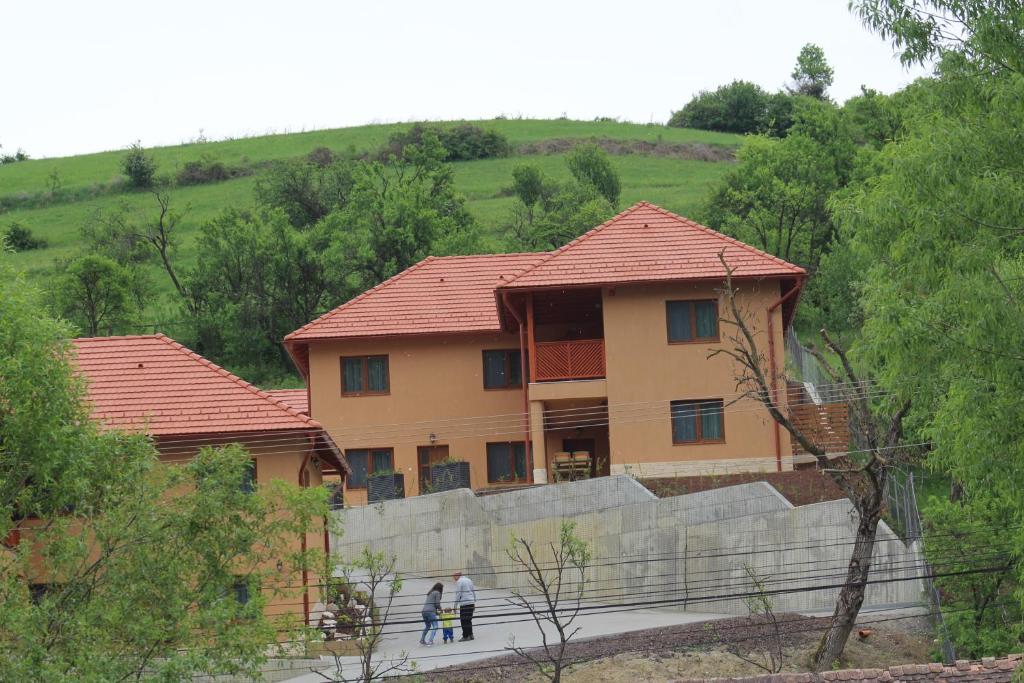 two people walking in front of a house at Casa 77*** Praid in Praid