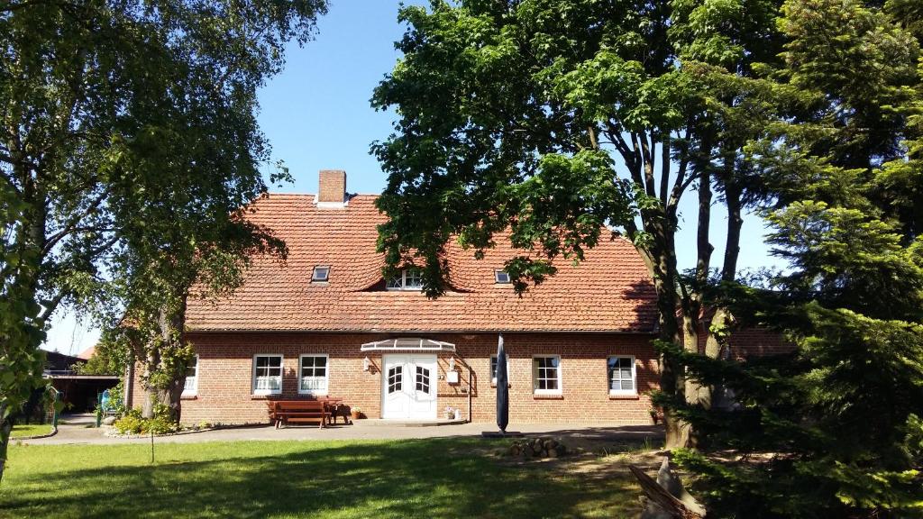 a large brick house with a white door at Pension Redefin in Redefin