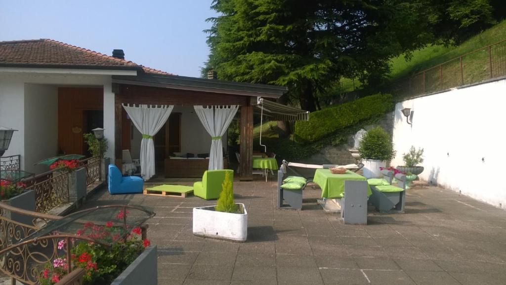 un patio con muebles verdes y azules en un patio trasero en B&B Il Santo Pellegrino, en Adrara San Rocco