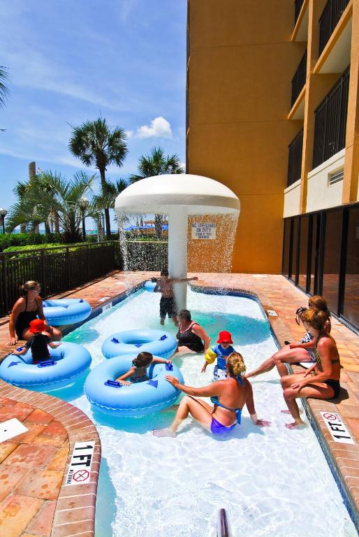 a group of people in a pool at a resort at Holiday Pavilion Resort on the Boardwalk in Myrtle Beach