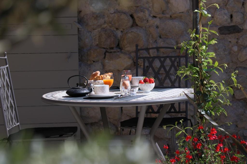 uma mesa com comida e bebidas em cima em Ancienne Cure em Buis-les-Baronnies