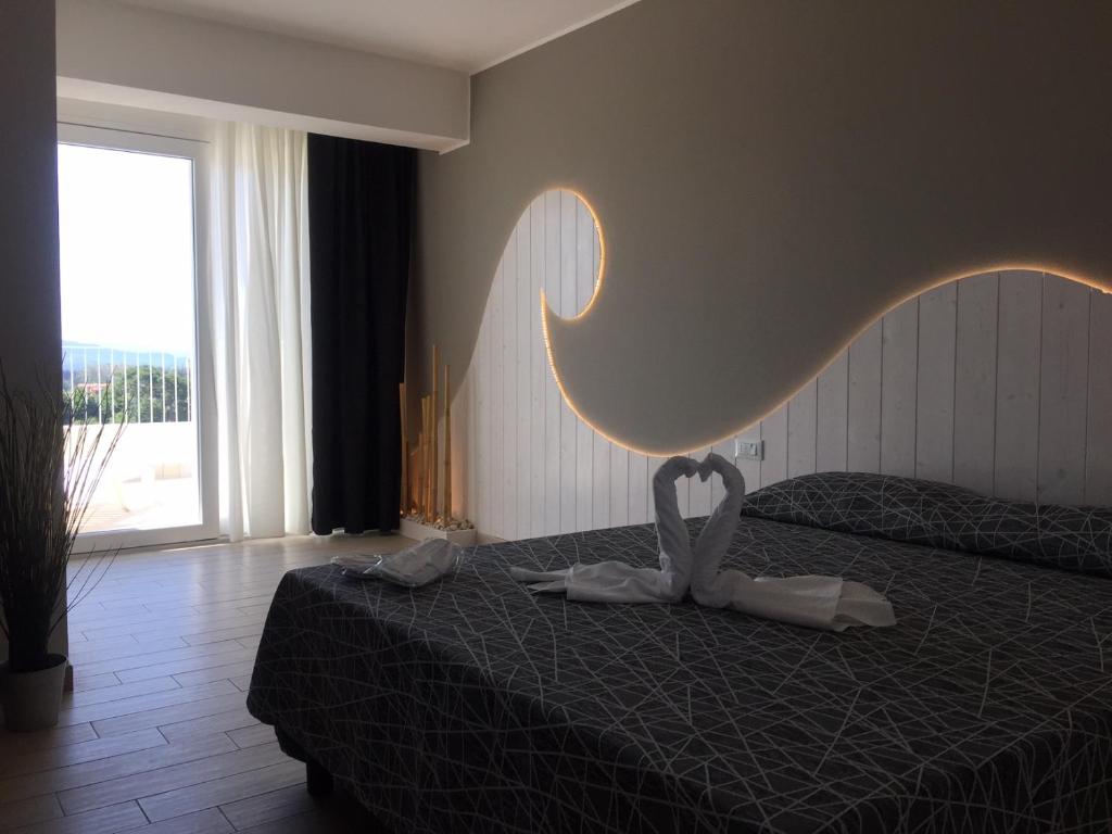 Postel nebo postele na pokoji v ubytování Hotel Letizia