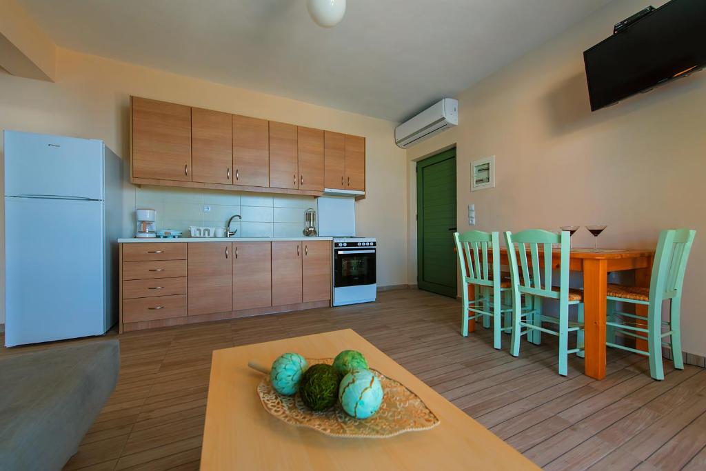 a kitchen and dining room with a table and a kitchen with a tablektop at Eltheo Villas in Agios Nikitas