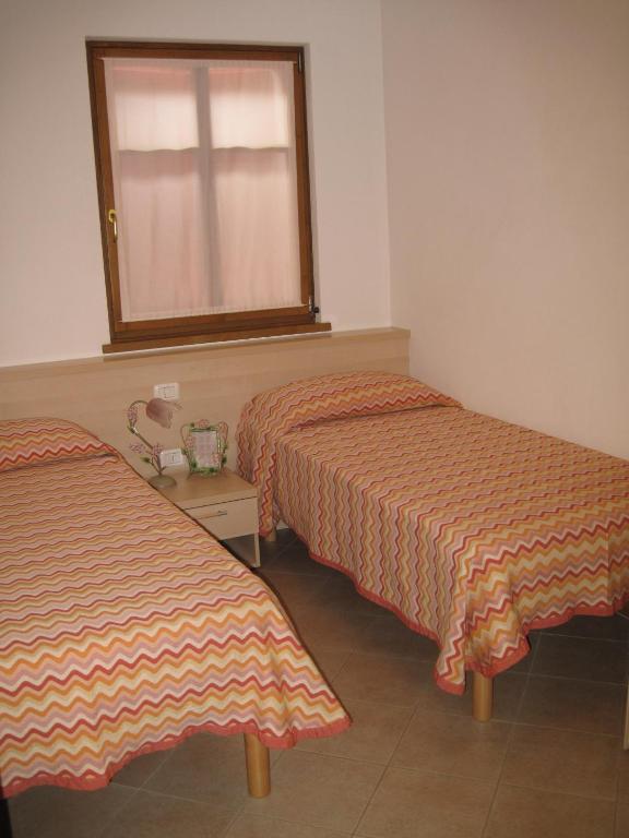 A bed or beds in a room at Residenza Cristina
