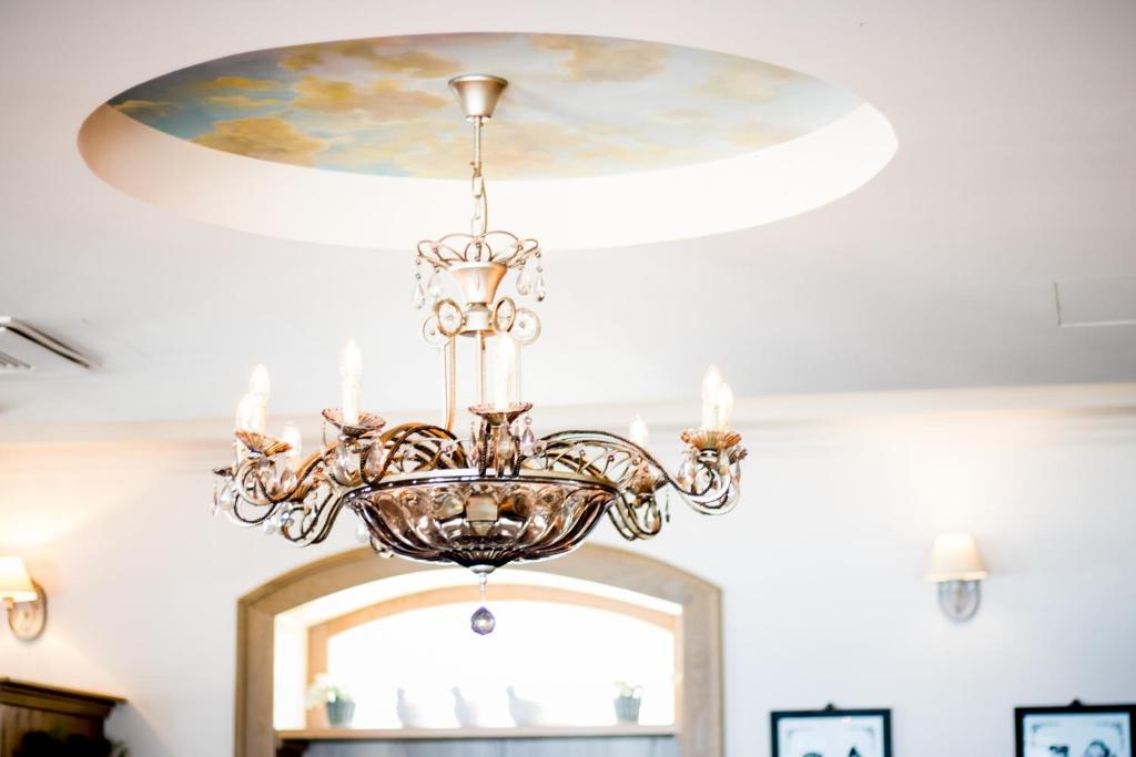 a chandelier hanging from a ceiling in a room at Hotel Piran in Piran