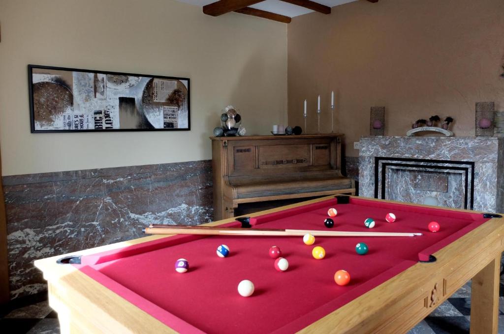 a pool table with billiard balls on top of it at Gites "Aux Legendes d Ardenne" in Paliseul